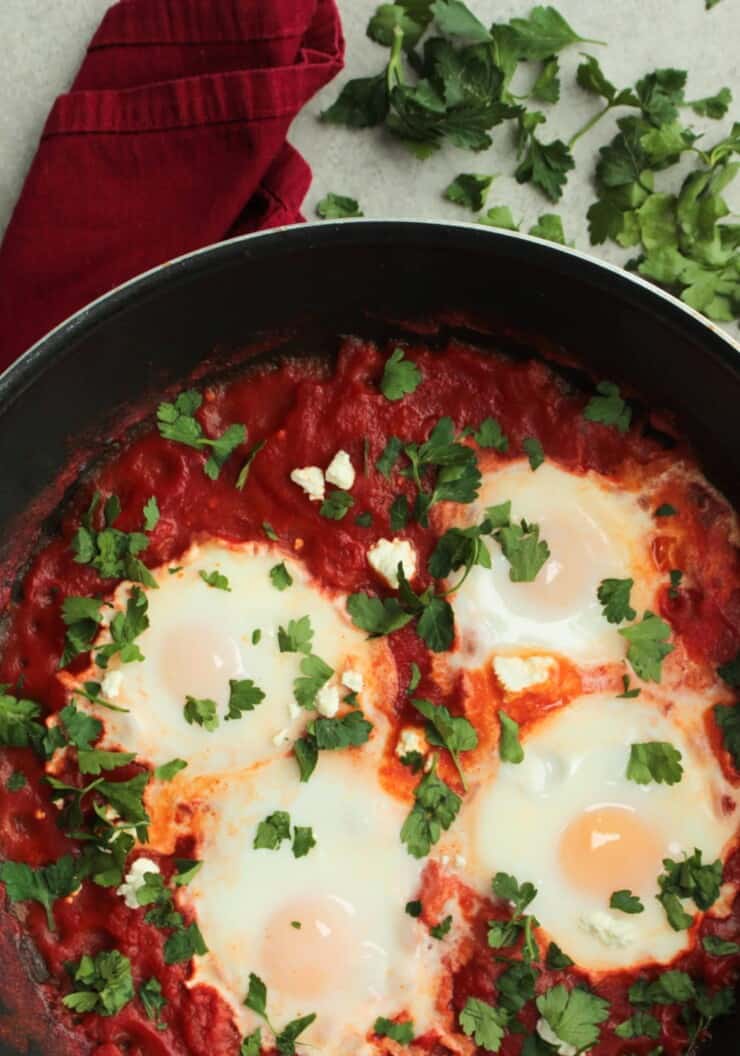 4 eggs cooked in tomato sauce in pan