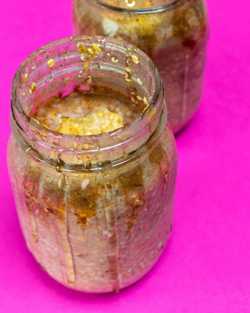 Oats in large glass jar with honey poured over top