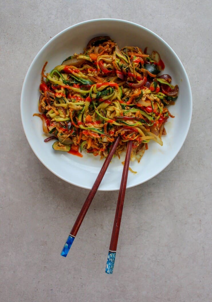 Bowl of colourful vegetables with chop sticks