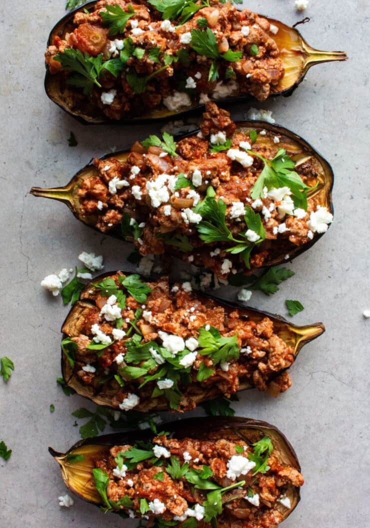 Roasted aubergines stuffed with mince and topped with feta
