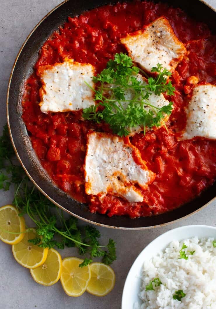 4 pieces of white fish in tomato sauce in large frying pan