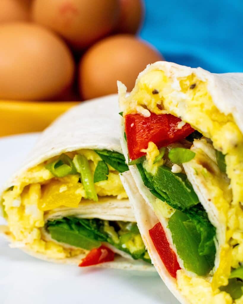 Breakfast Burrito sliced in half with egg and salad