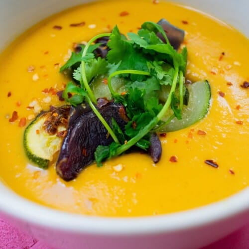 Bowl of satay soup topped with roasted vegetables