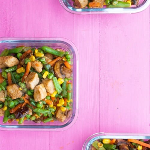 Overhead shot of glass meal prep containers filled with vegetable stir fry