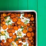 Overhead shot of sweet potato slices and cooked eggs in large baking tray