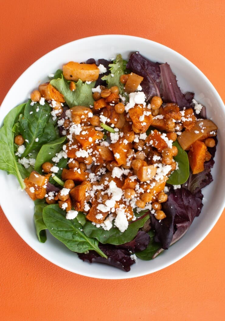 Overhead shot of bowl of salad with roasted butternut squash and feta