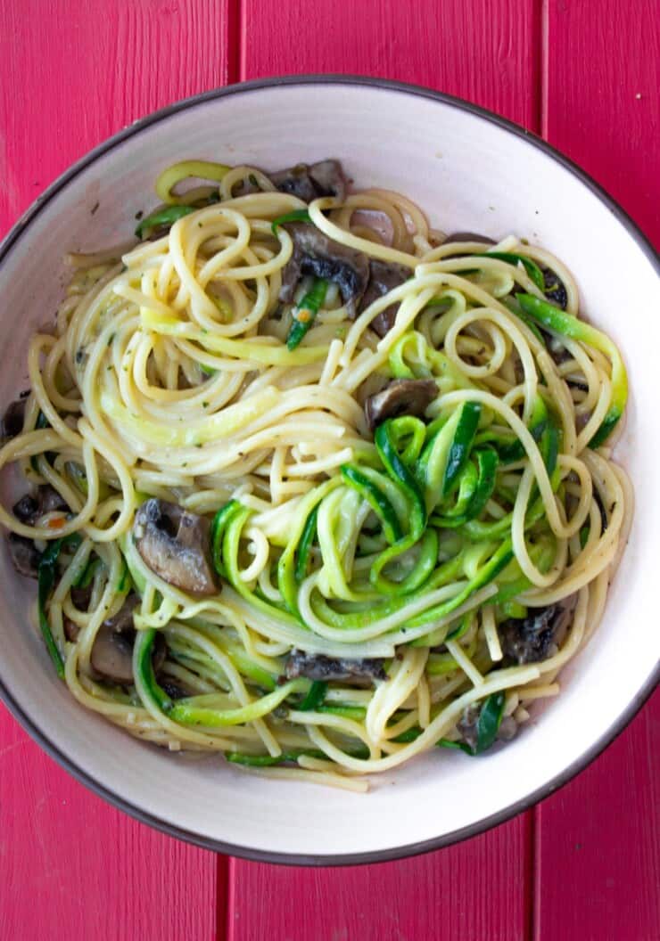 Overhead shot of bowl of spaghetti with mushrooms and spiralised courgettes