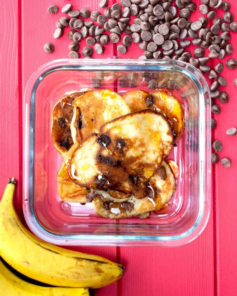 Pancakes in a meal prep dish with chocolate chips and banana