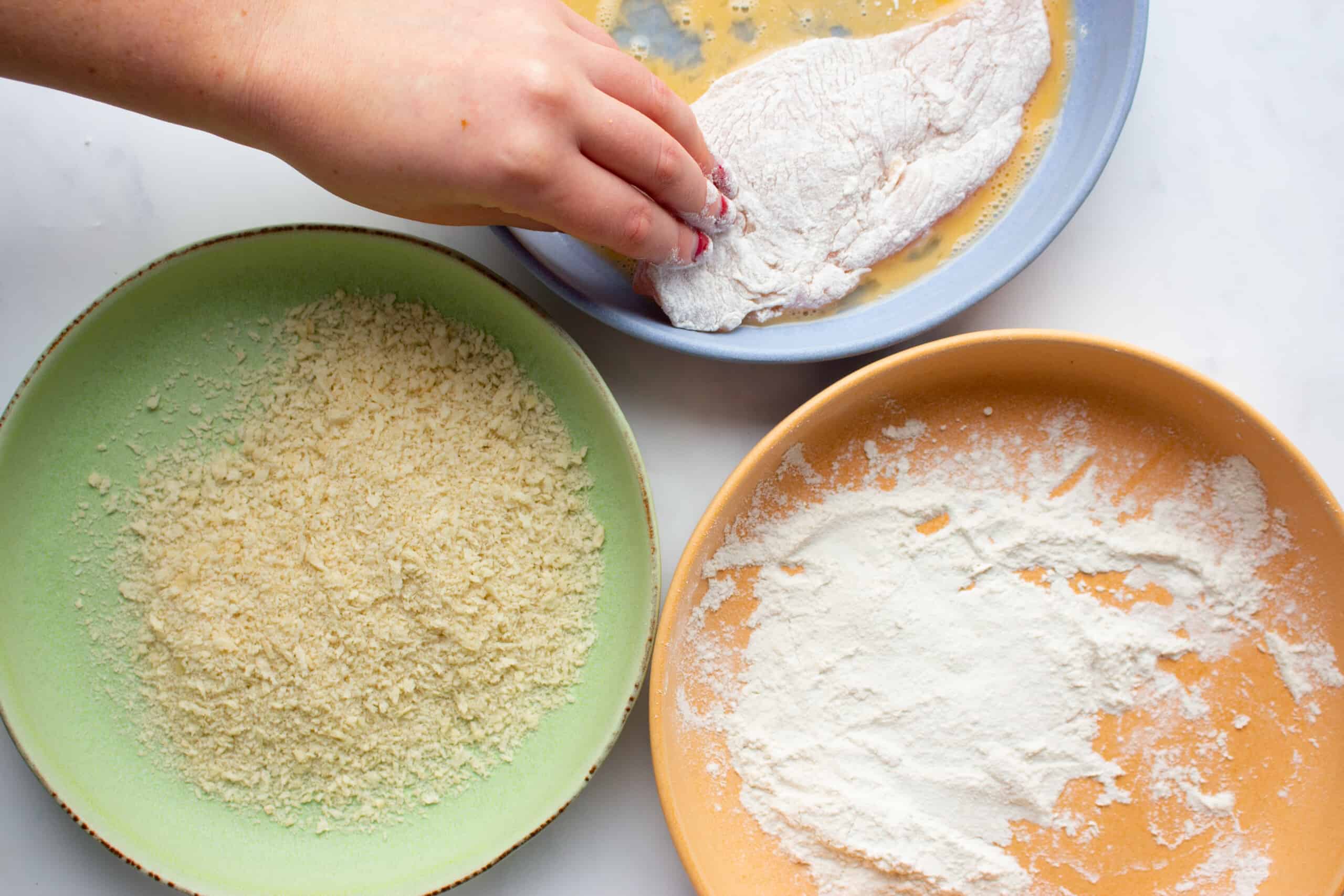 3 plates with flour, egg and bread crumbs
