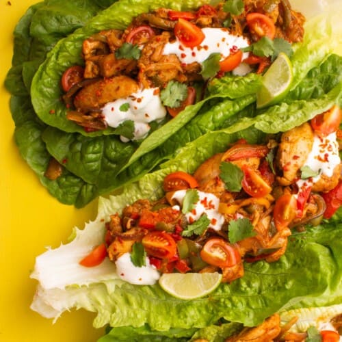 Overhead shot of romaine lettuce leaves filled with chicken fajitas