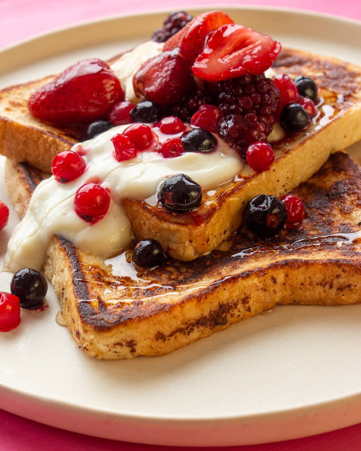 Close up photo of French toast with yogurt and berries on a plate