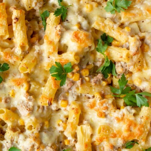Close up of Creamy tuna pasta bake with sweetcorn and topped with fresh parsley.
