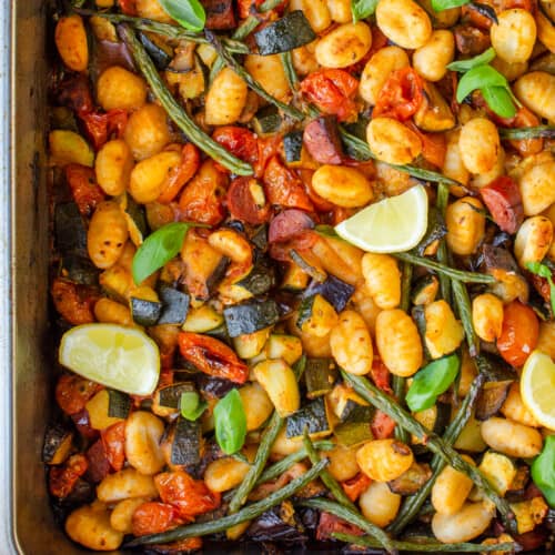 Close up shot of gnocchi roasted in a tray with mediterranean vegetables, paprika &oregano