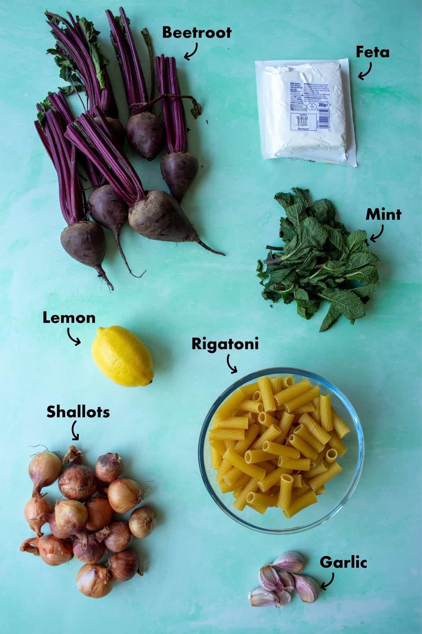 Ingredients to make Pink Pasta laid out on a pale blue background and labelled.
