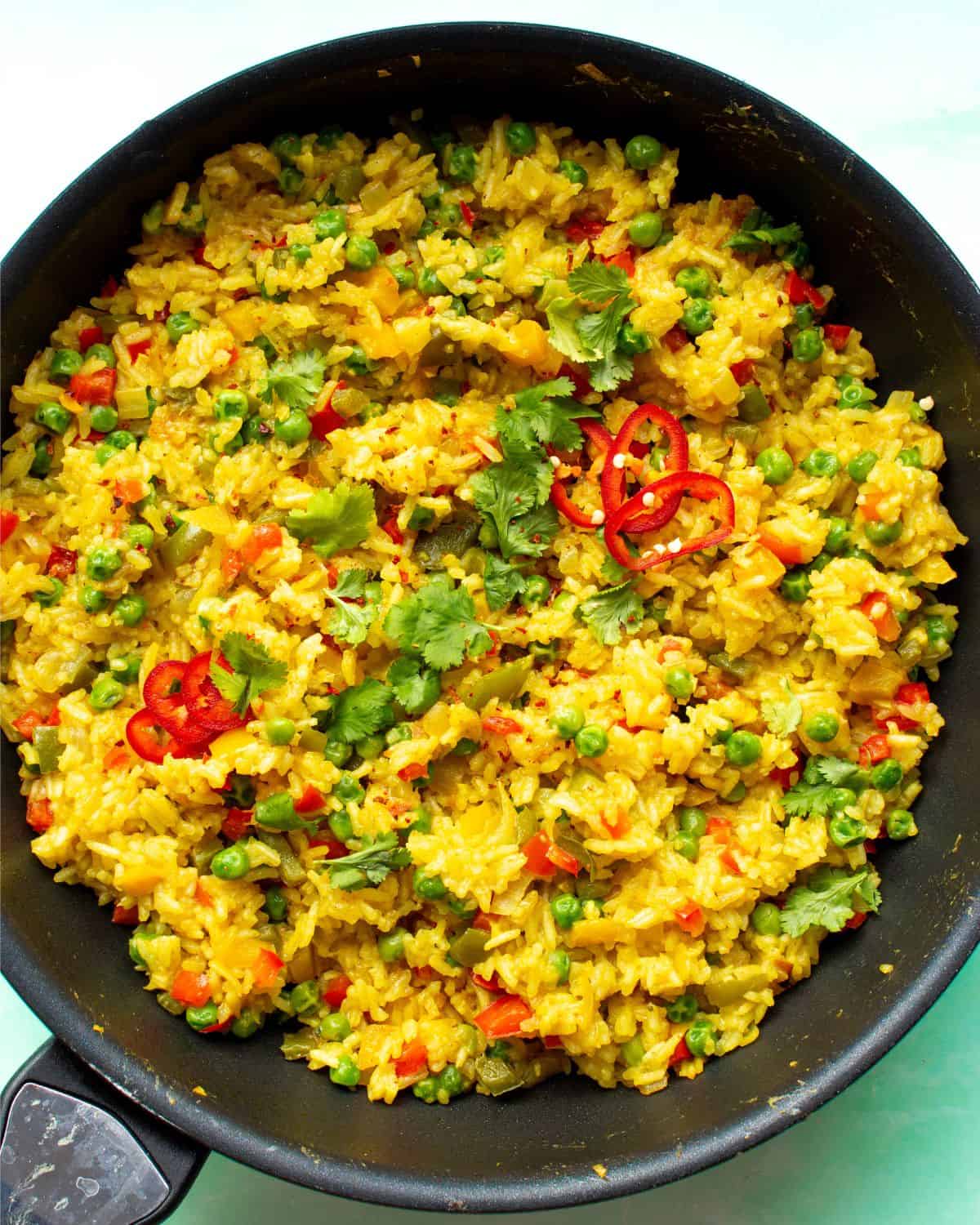 Nando's spicy rice topped with fresh cred chilli slices and coriander.
