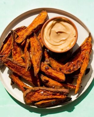Sweet Potato wedges pm a plate with some dipping sauce