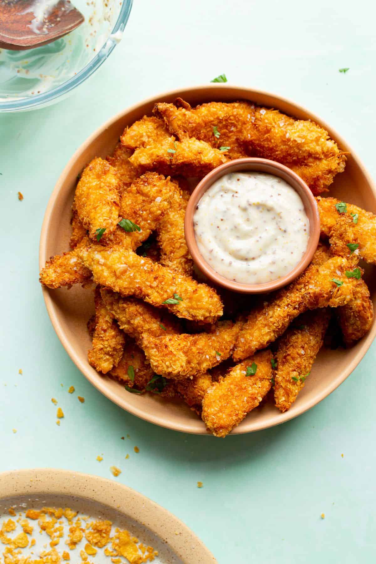 Chicken goujons on paste with dip dressing.