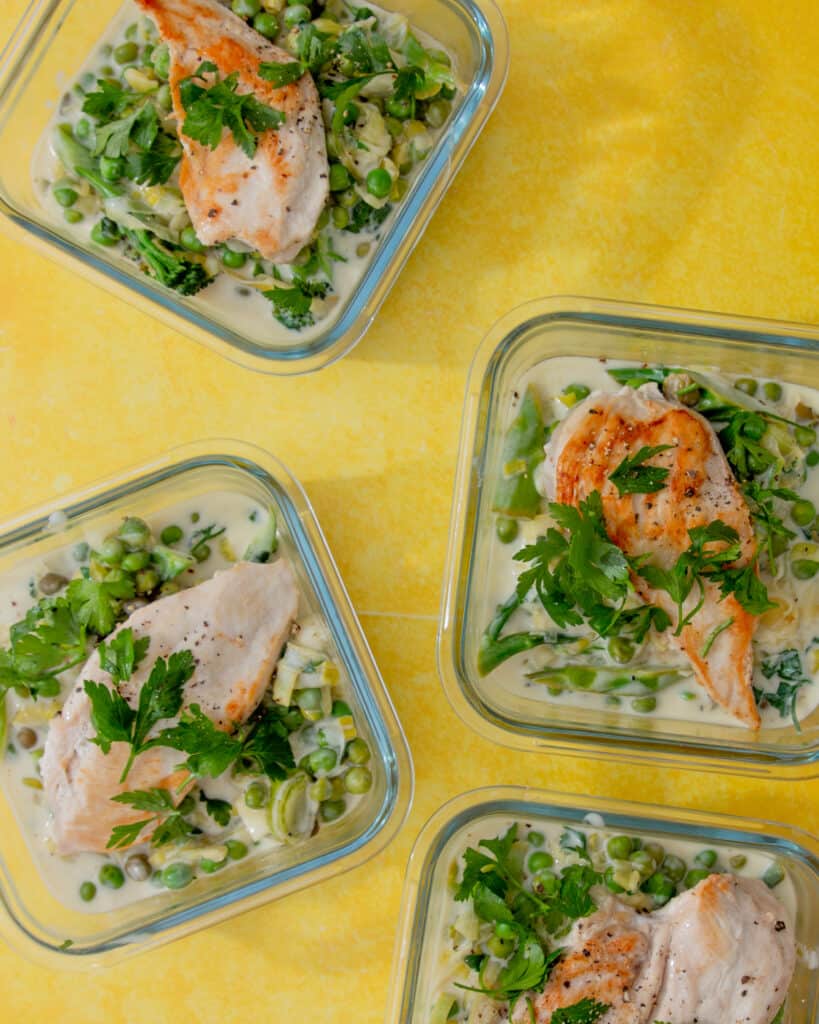 Creamy Lemon Chicken with Greens in 4 meal prep containers.