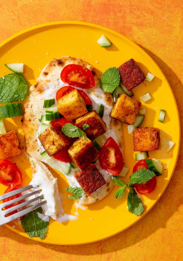 Crispy Fried Paneer with Naan served with cherry tomatoes, cucumber, mint and yogurt.