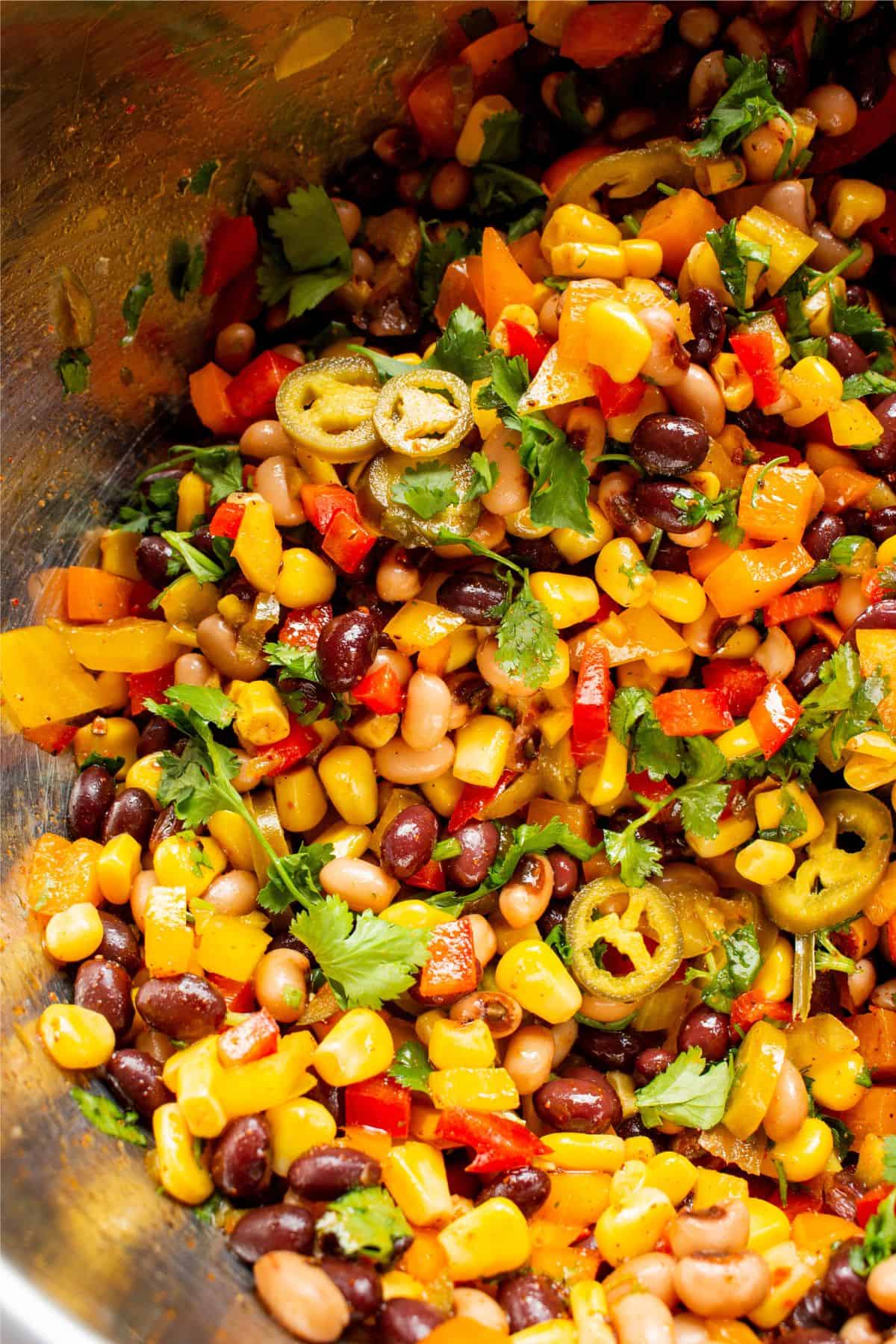 Close up of mixed bean salad, with sweet corn, peppers and coriander.