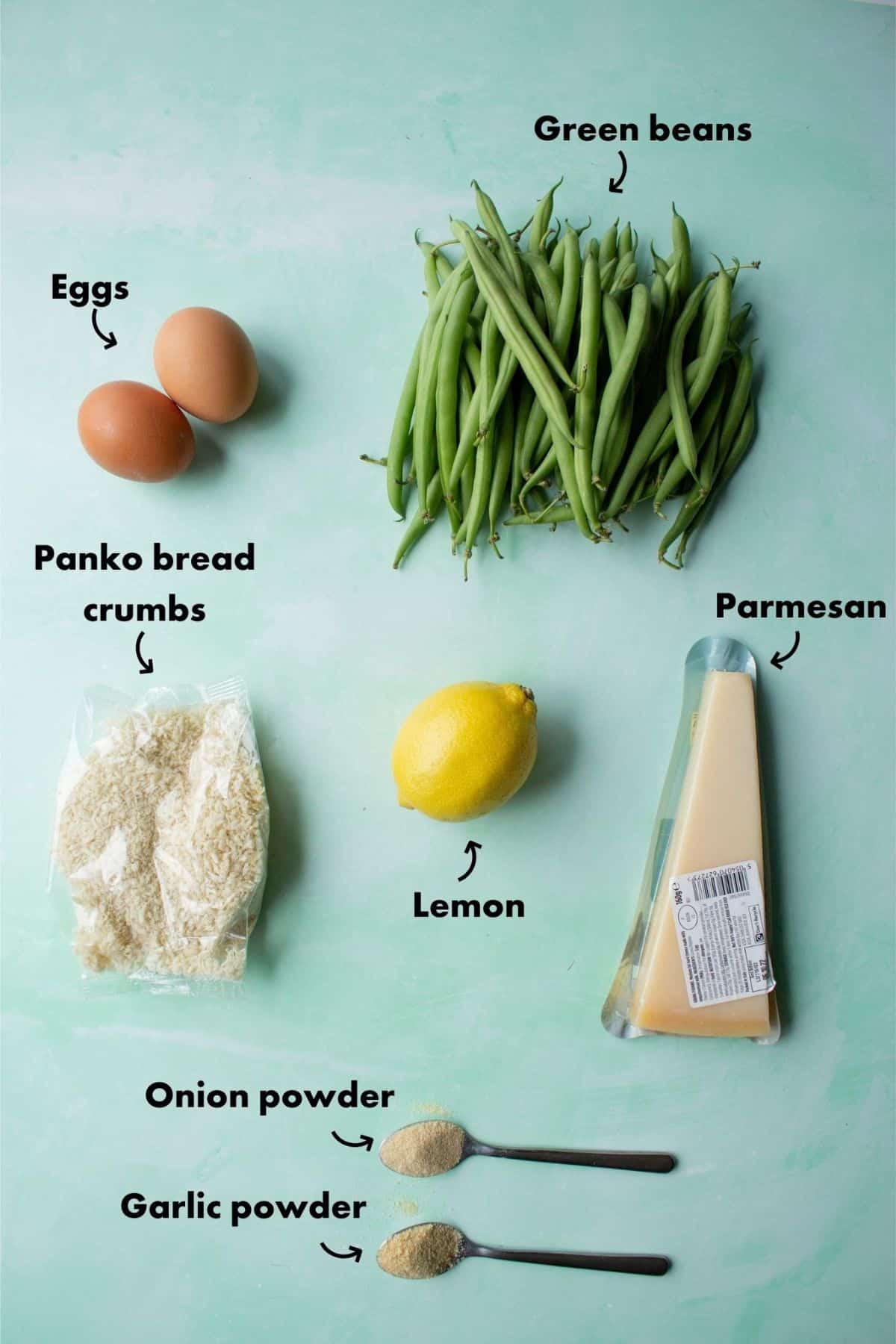 Ingredients to make popcorn chicken laid out on a pale blue background and labelled.