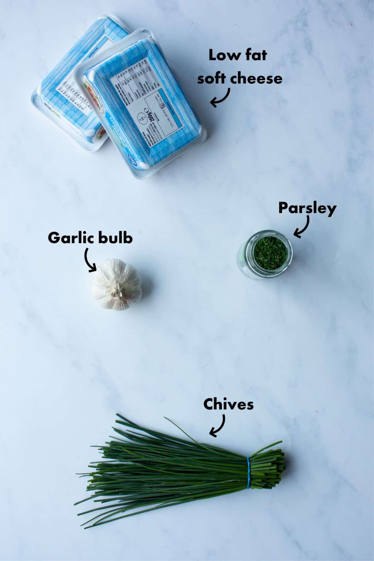 Ingredients to make Budget Philadelphia cheese laid out on a greyish background and labelled.