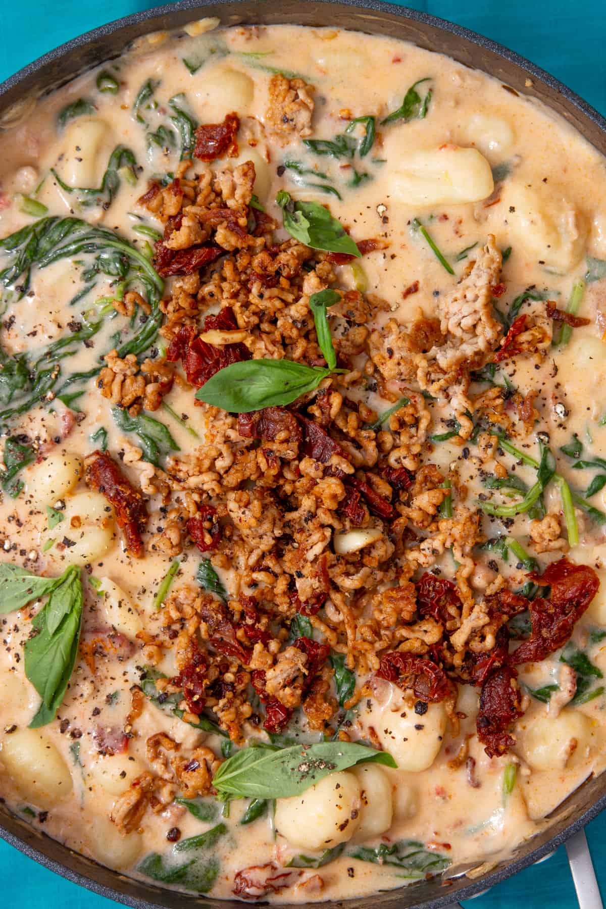Gnocchi with a creamy sauce with pork mince, spinach and sun-dried tomatoes topped with basil and extra browned pork and sun-dried tomatoes.