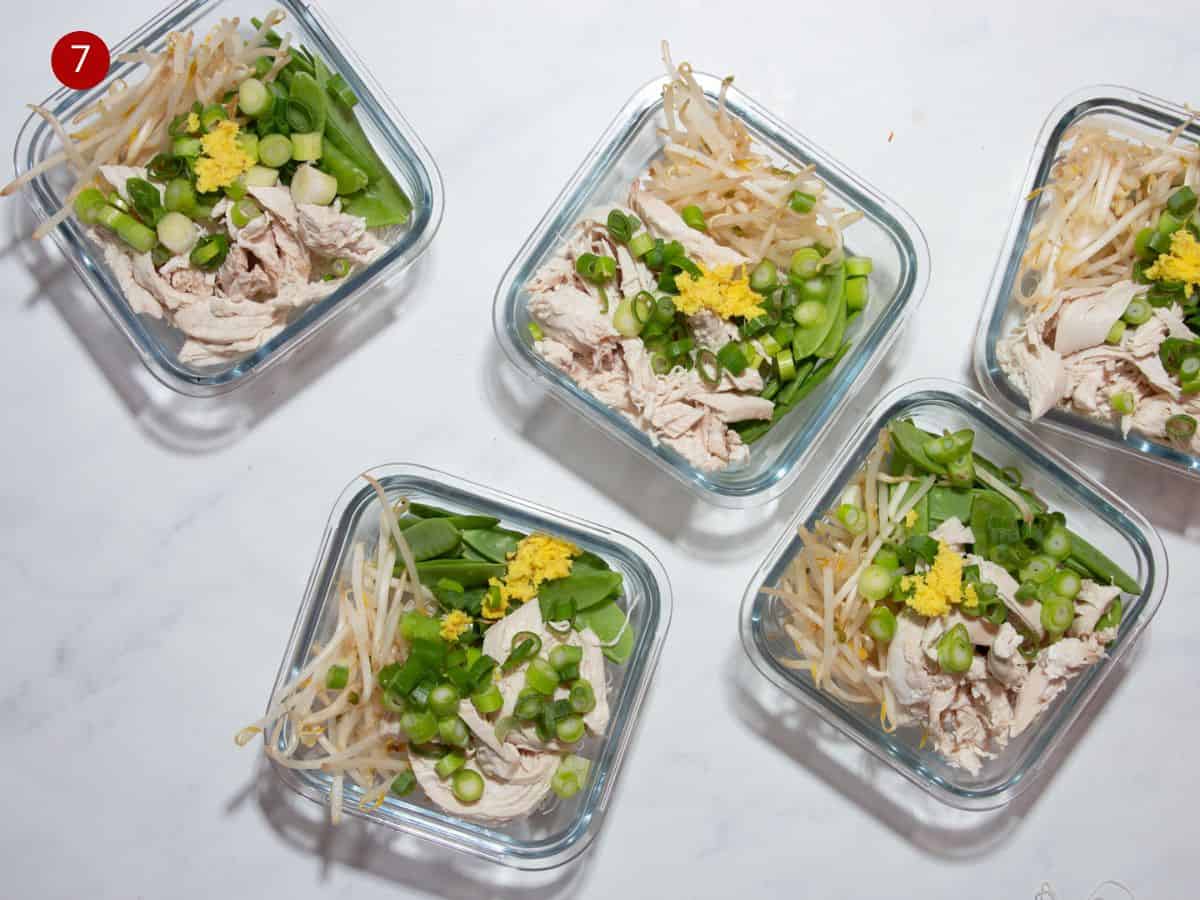 overhead shot of 5 square, glass meal prep containers with beansprouts, chickn slices, spring onion, ginger and mange tout.