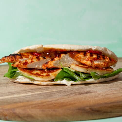 Pitta bread filled with golden browned halloumi, chicken, lettuce, mayo and relish.
