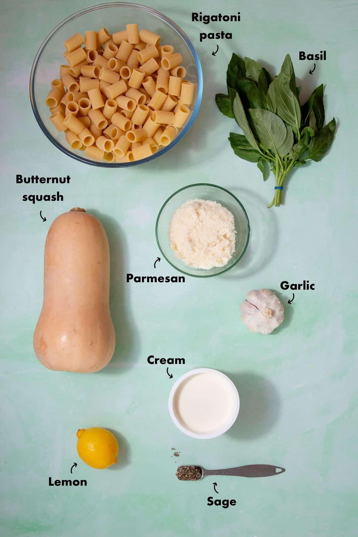 Ingredients to make butternut squash pasta laid out on a pale blue back ground and labelled.