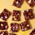 Rectangular pieces of chocolate cake topped with bits of sugar coated Easter eggs.