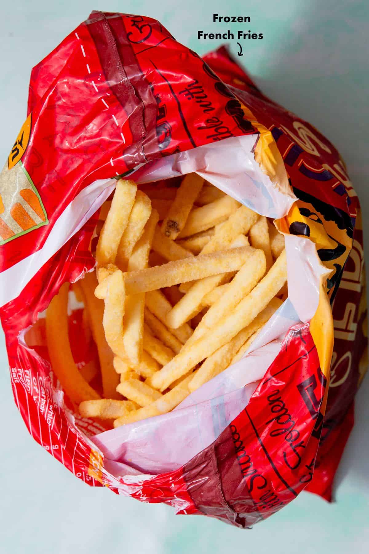 An open plastic packaging with frozen French fries.