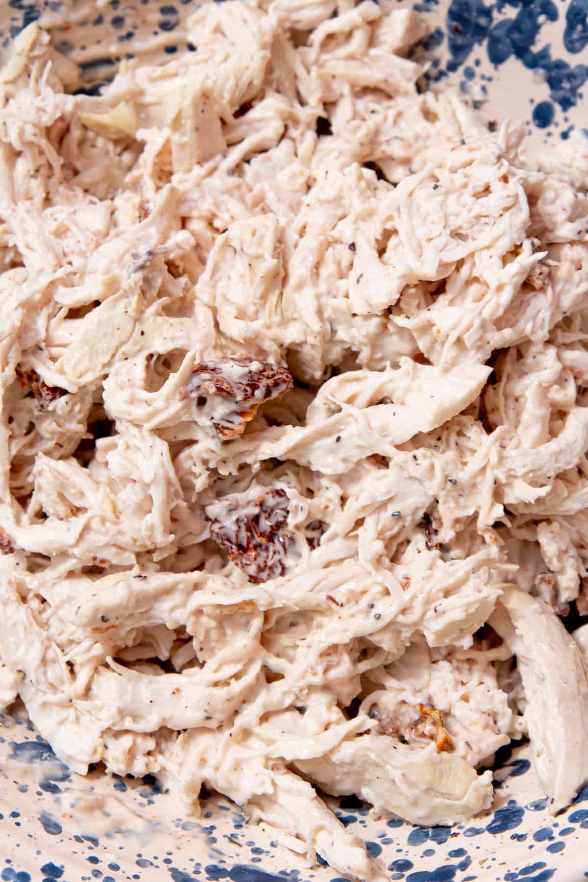 Shredded chicken with some dressing mixed in.


