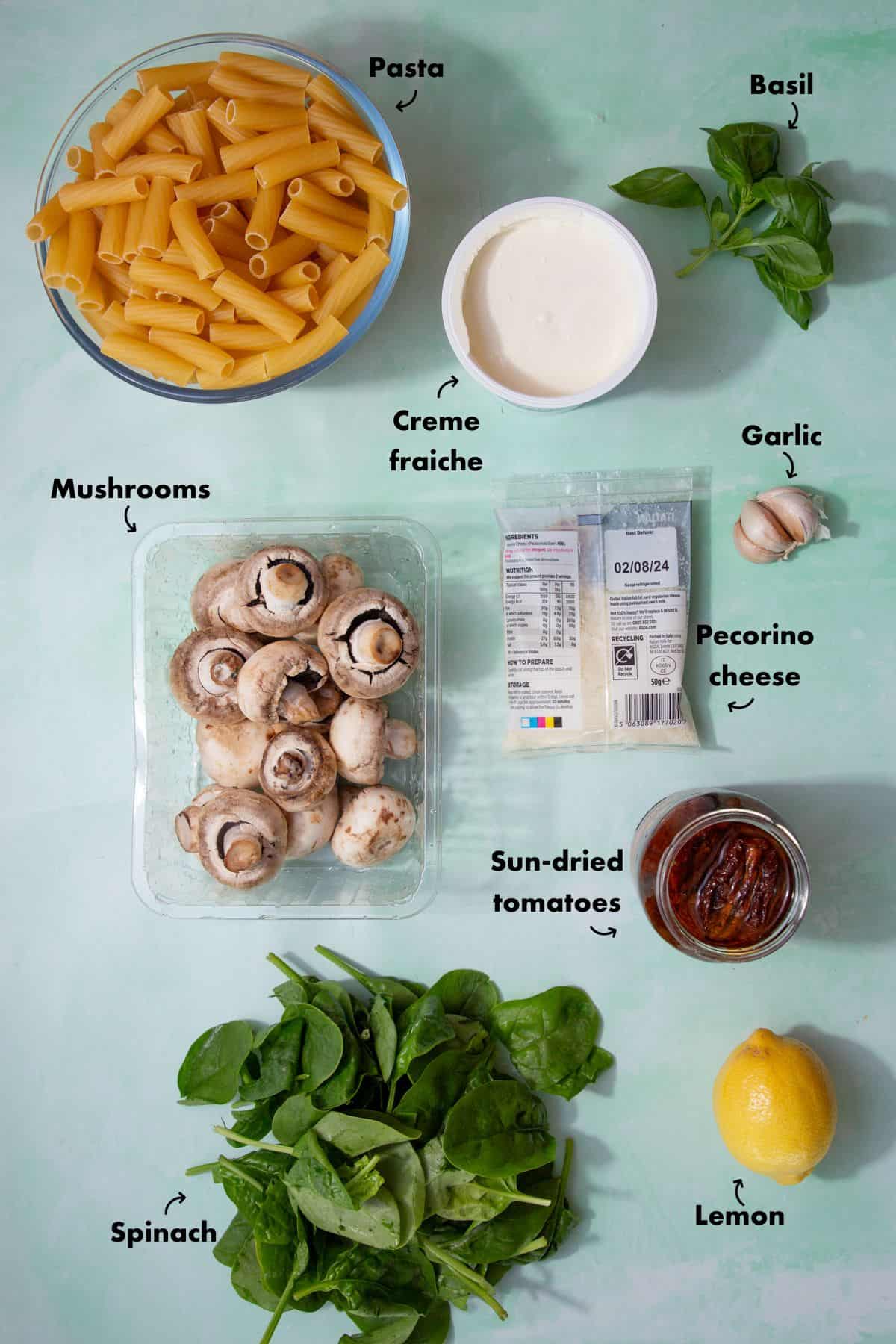 Ingredients to make creme fraiche pasta laid out on a pale blue background and labelled.