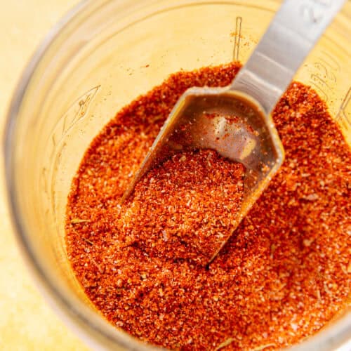 pork chop seasoning spices in a glass bowl on a yellow background