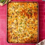fully baked and golden brown sheet pan eggs on a red background