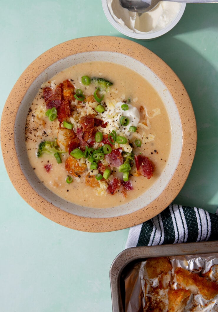 prepared hash brown potato soup with bacon, chives and sour cream toppings