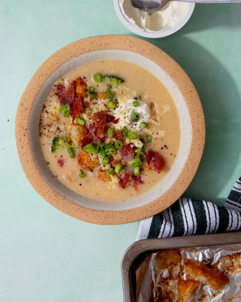 prepared hash brown potato soup with bacon, chives and sour cream toppings