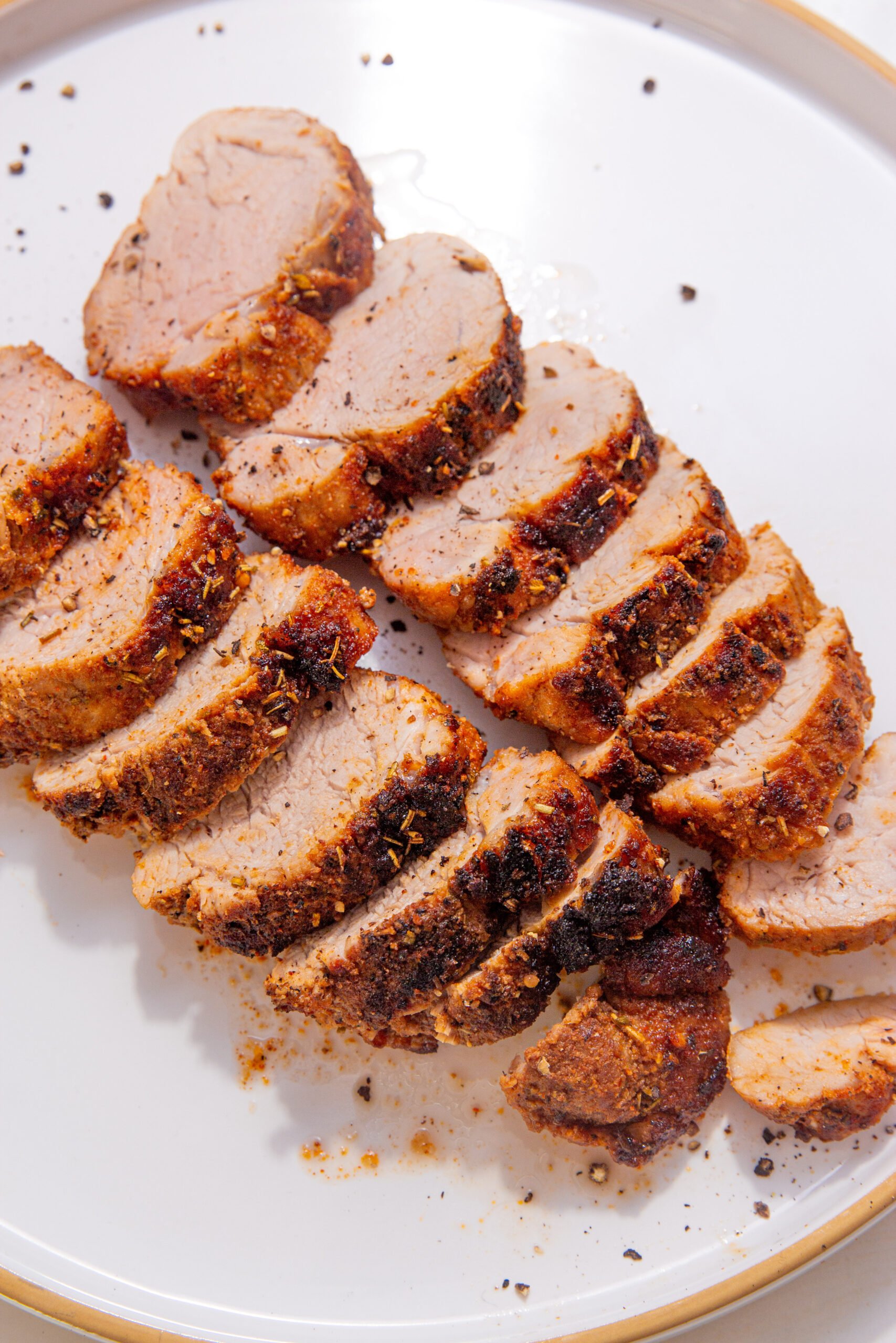 Fully cooked air fryer pork tenderloin seasoned with dry rub