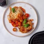 image of crumpets with melted cheese marmite, butter, cherry tomatoes, and basil