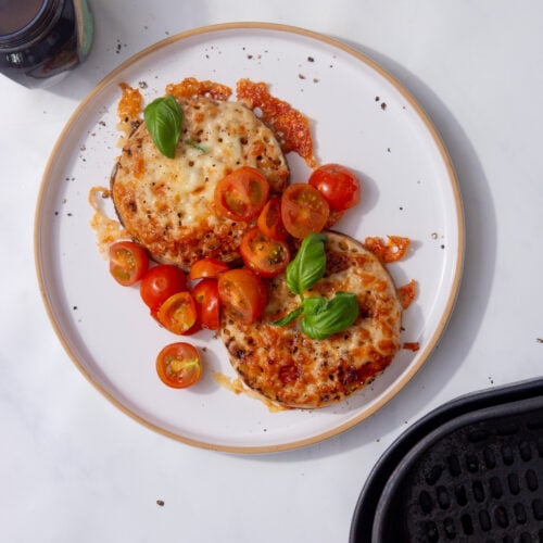 image of crumpets with melted cheese marmite, butter, cherry tomatoes, and basil