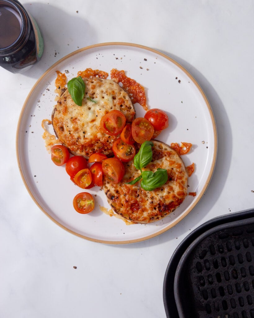 image of crumpets with melted cheese marmite, butter, cherry tomatoes, and basil