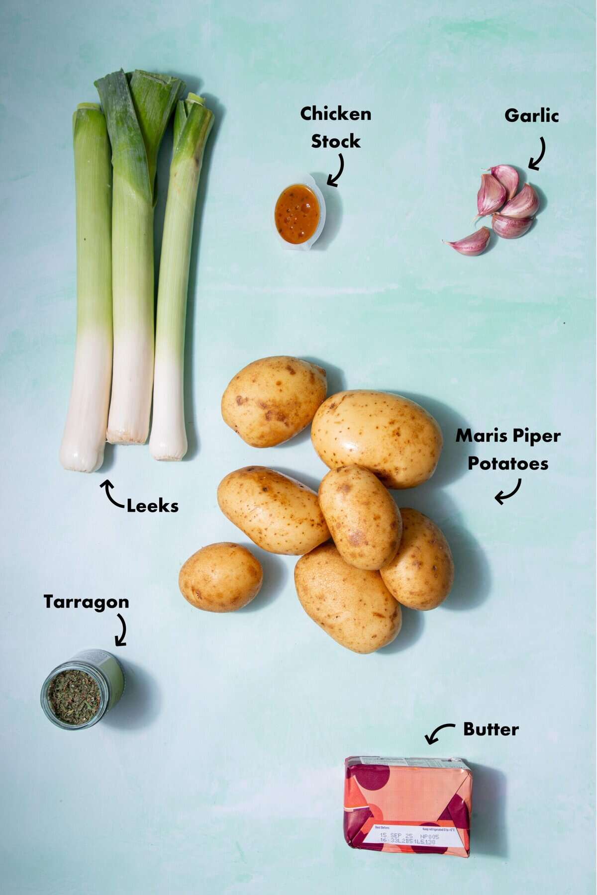 Ingredients laid out on a pale blue background with arrows pointing to the different food items.