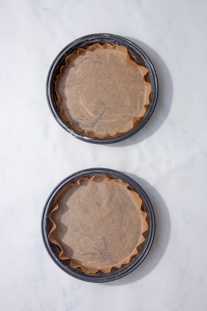 two cake tins lined with parchment paper. 
