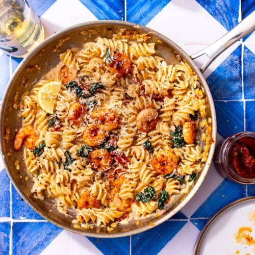 Creamy marry me shrimp pasta with shrimp, cavolo nero, sun-dried tomatoes, and parmesan in a skillet.
