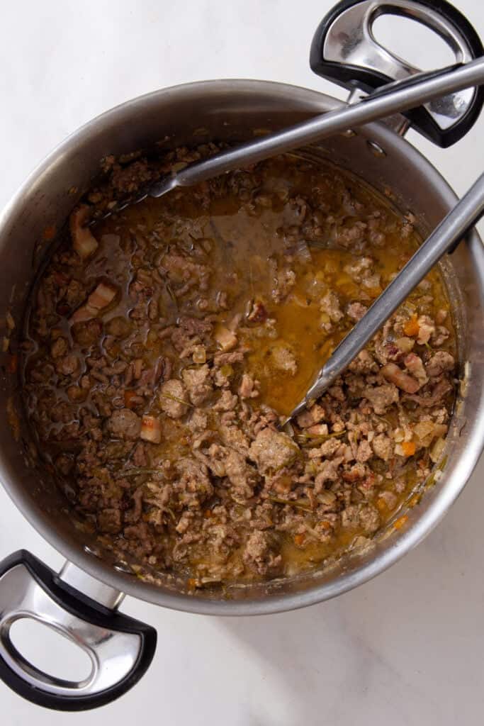 Slow-cooked ragu in a pot after hours of gentle simmering.