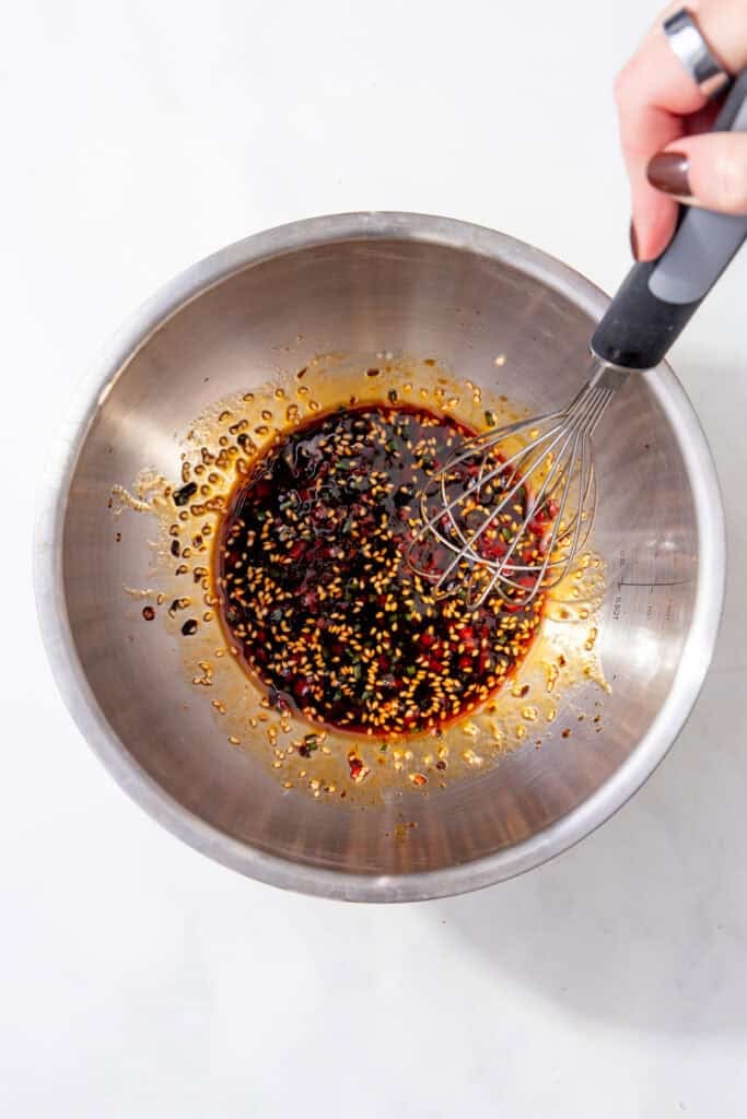 Finished gyoza dipping sauce in a mixing bowl, ready to serve with dumplings.