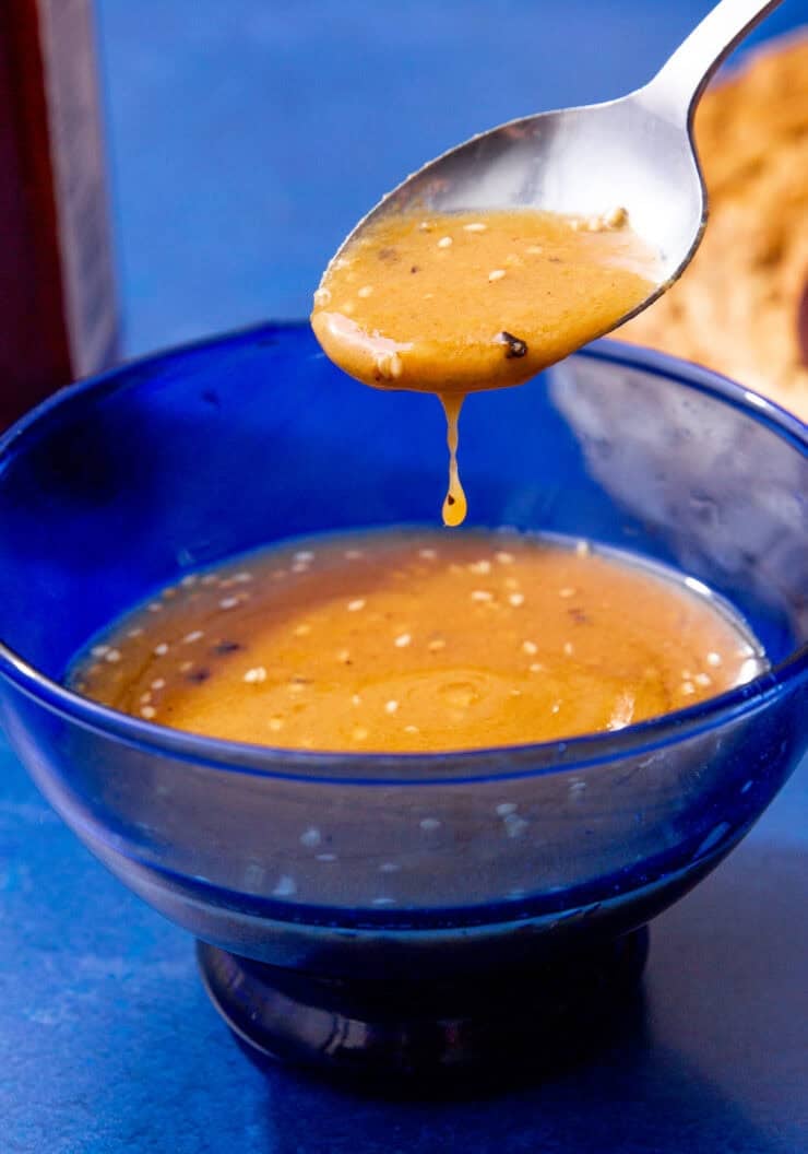 Close-up of a miso dressing recipe in a blue bowl.