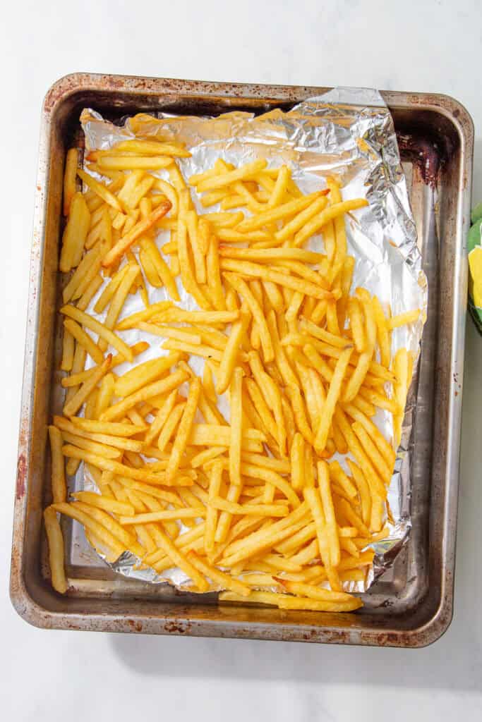 Golden baked fries fresh from the oven, slightly crisp around the edges.