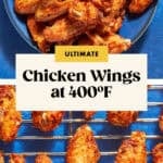 A bowl of golden, crispy chicken wings sits above a rack of freshly baked wings on a blue background. Text in the center reads: ULTIMATE Chicken Wings at 400ºF—discover how long to bake chicken wings at 400°F for perfect results.